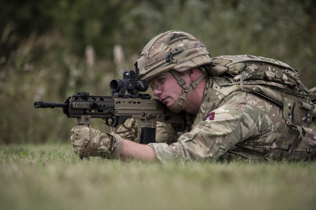 A soldier with a rifle painted with cerakote