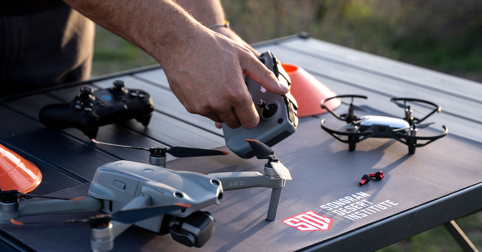 Drone setup and controller in use on SDI-branded mat outdoors