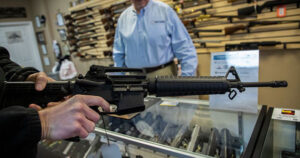 A first-time gun buyer purchases a rifle, marking the beginning of their firearms journey.