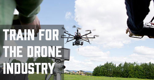 Two operators fly a professional multirotor drone in a field, representing hands-on drone training through SDI's online uncrewed technology programs.