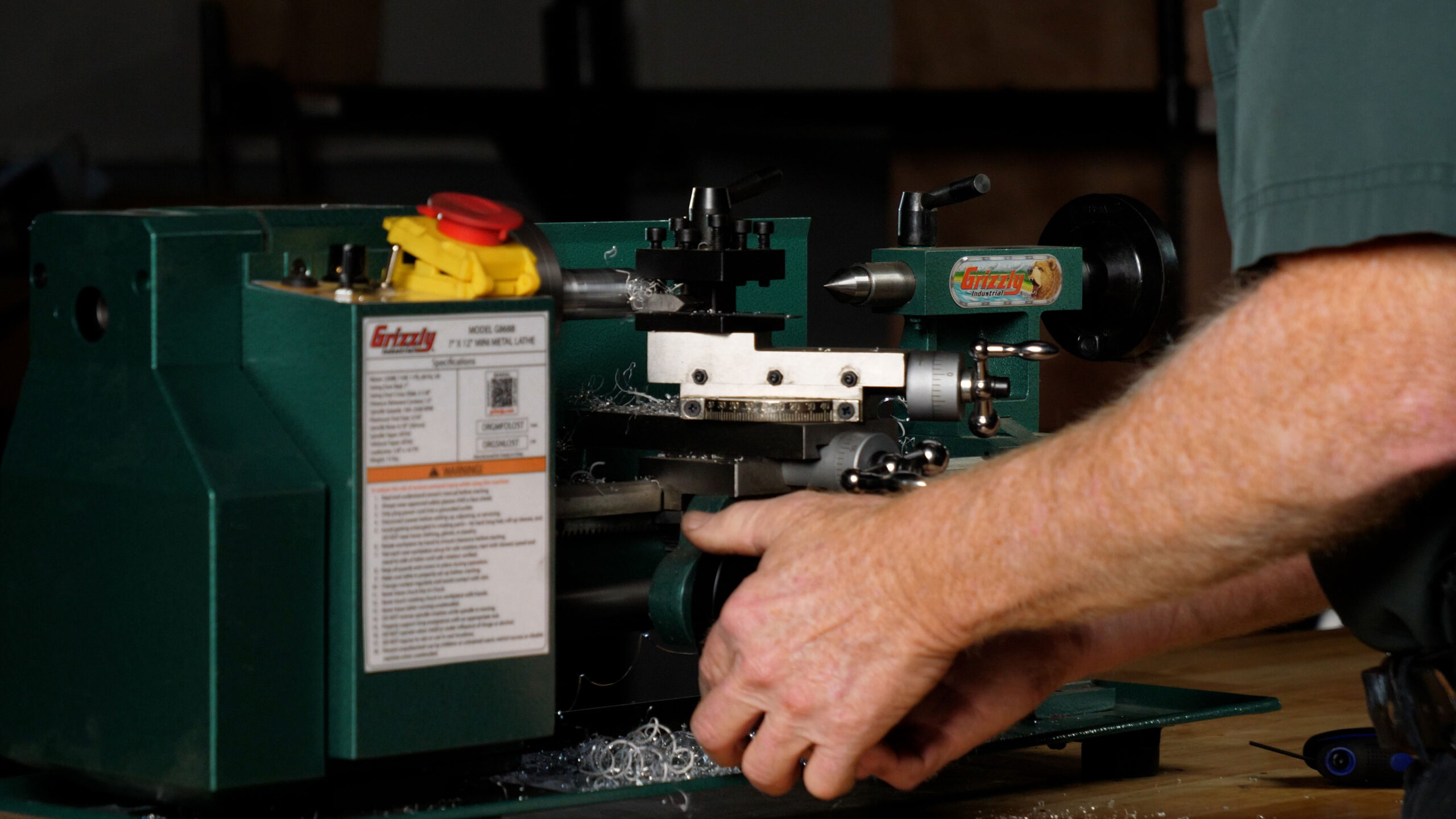 Student using a Grizzly tabletop lathe for hands-on gunsmithing training at Sonoran Desert Institute.
